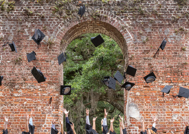grads throwing mortarboards in the air